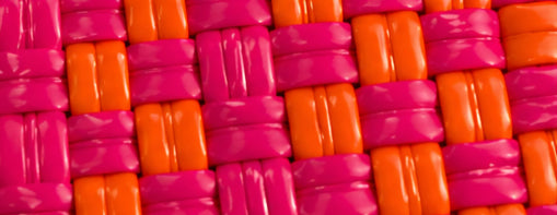 Close-up of the Tequila Sunrise pink and orange woven pattern Gala Bag